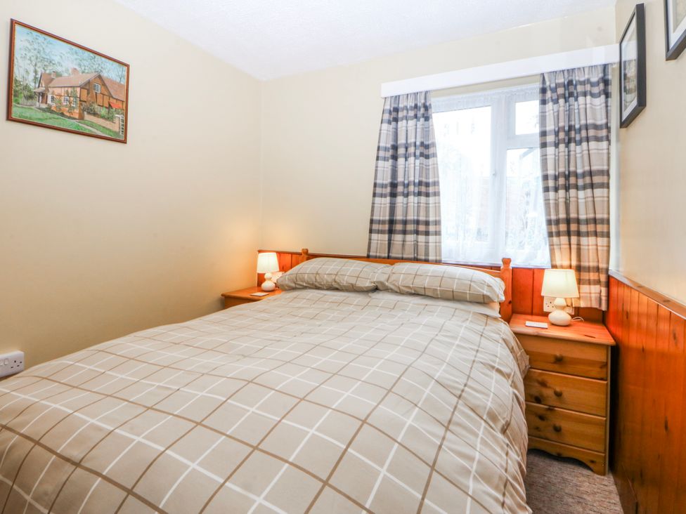 A bedroom with a bed and bedside table at Ground Floor Apartment in Tremadog