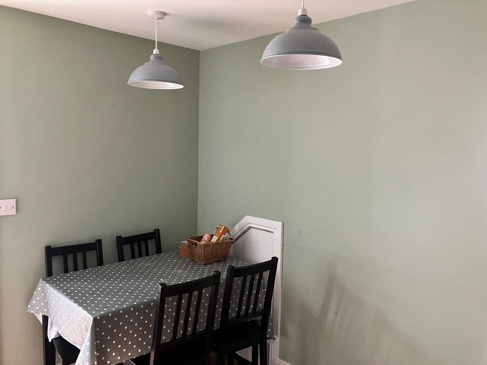 A dining room with a table and chairs at Silver Birch House in Beaufort Killarney, County Kerry