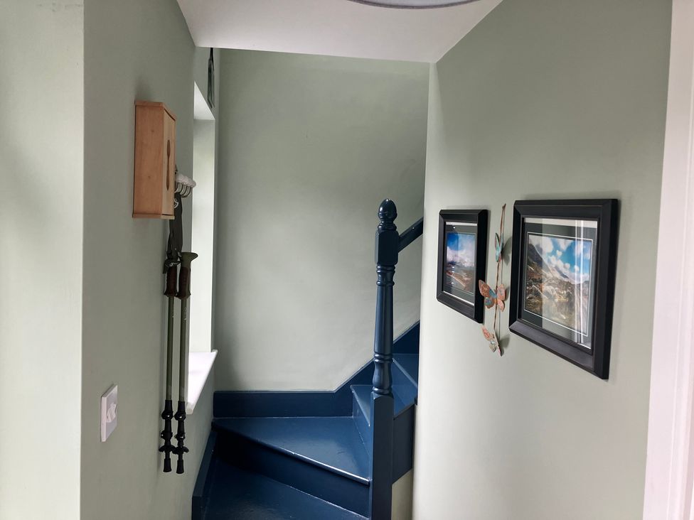 A staircase with wall hooks and pictures in the hallway at Silver Birch House, Beaufort Killarney, County Kerry