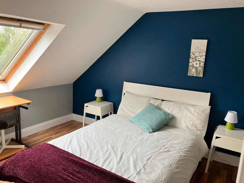 A bedroom with a bed and desk at Silver Birch House Beaufort Killarney County Kerry