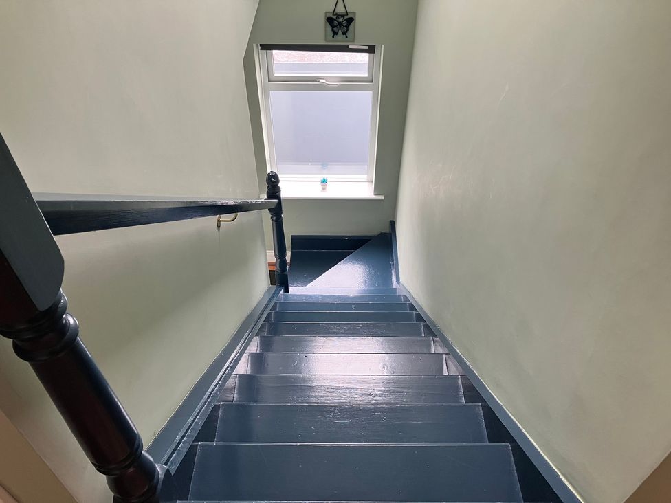 A staircase with a window at Silver Birch House in Beaufort Killarney, County Kerry