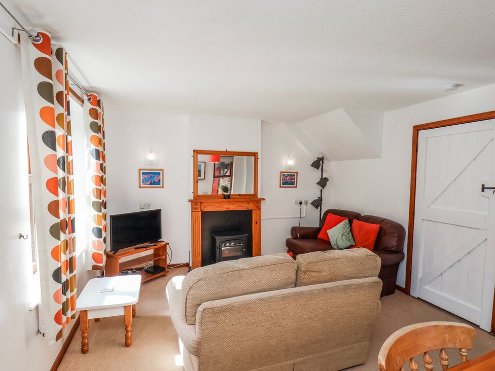 A living room with sofa and television at Waterside Cottage in Whitby