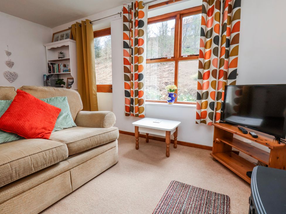 A living room with a sofa and television at Waterside Cottage in Whitby
