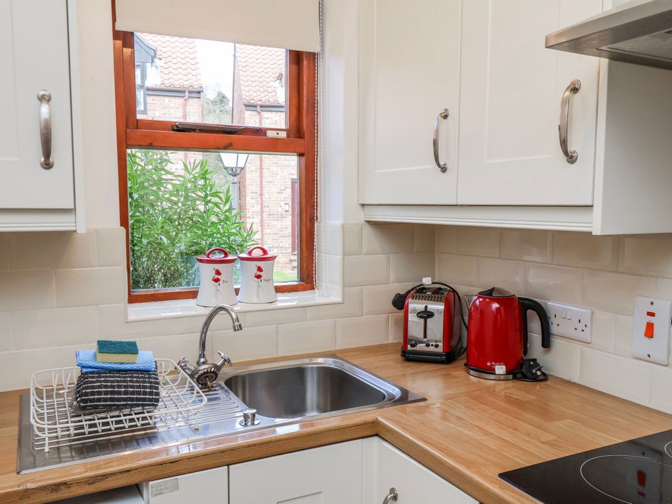 A kitchen with a sink and kettle at Waterside Cottage in Whitby