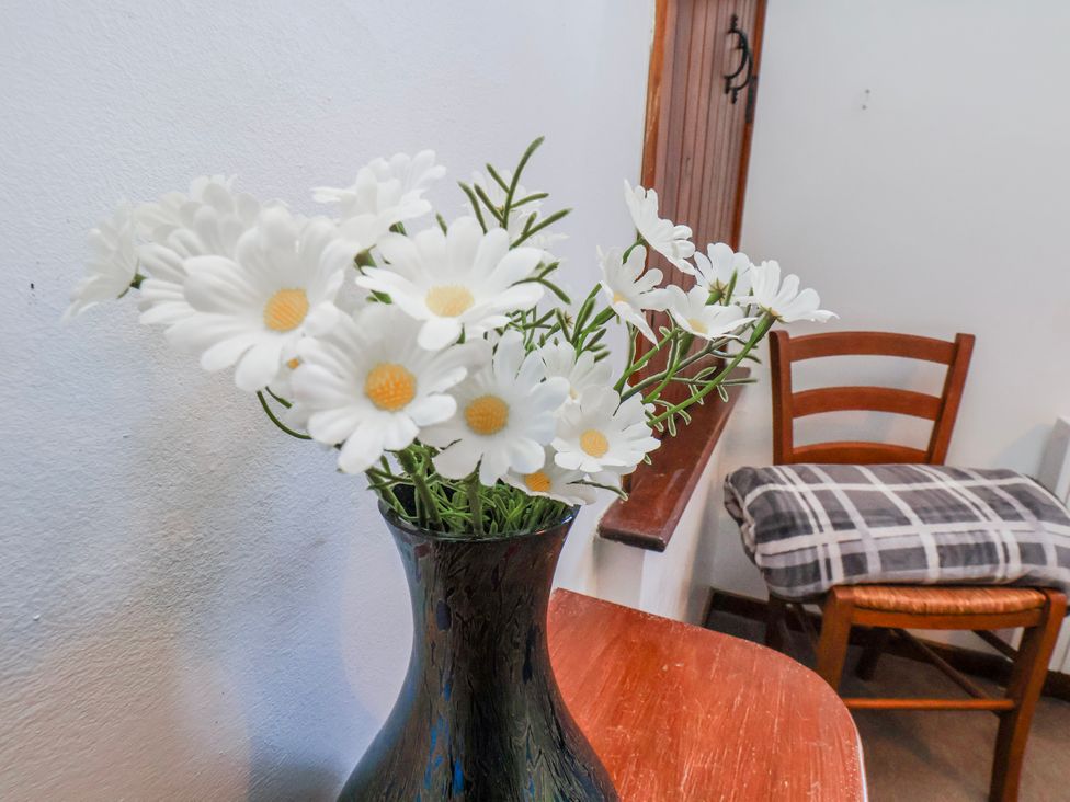 A vase with flowers on a table at Waterside Cottage in Whitby