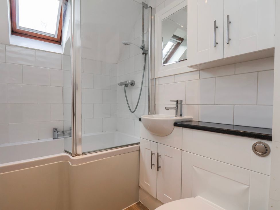 A bathroom featuring a bathtub, shower, sink, and toilet at Waterside Cottage in Whitby