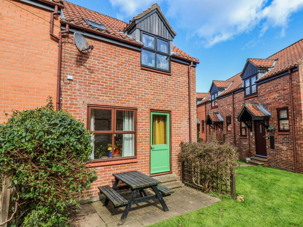 An outdoor area with a table and chairs at Waterside Cottage in Whitby