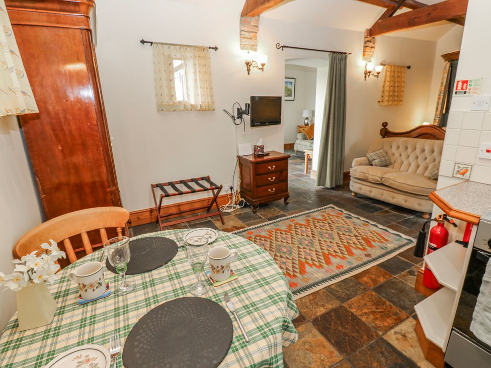 A dining room with a table and chairs at Lovesome Cottage in Northallerton