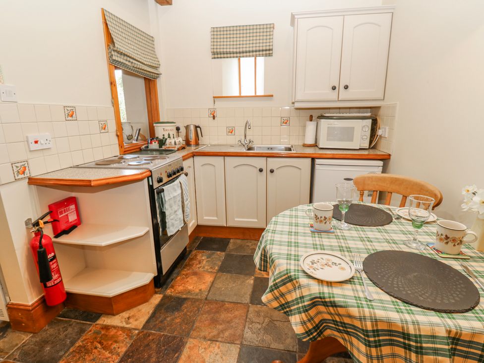 A kitchen with a stove and sink at Lovesome Cottage in Northallerton