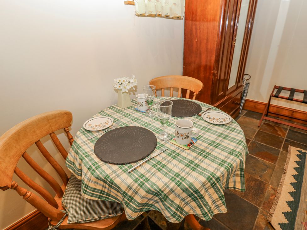 A dining room with a table set for two at Lovesome Cottage in Northallerton
