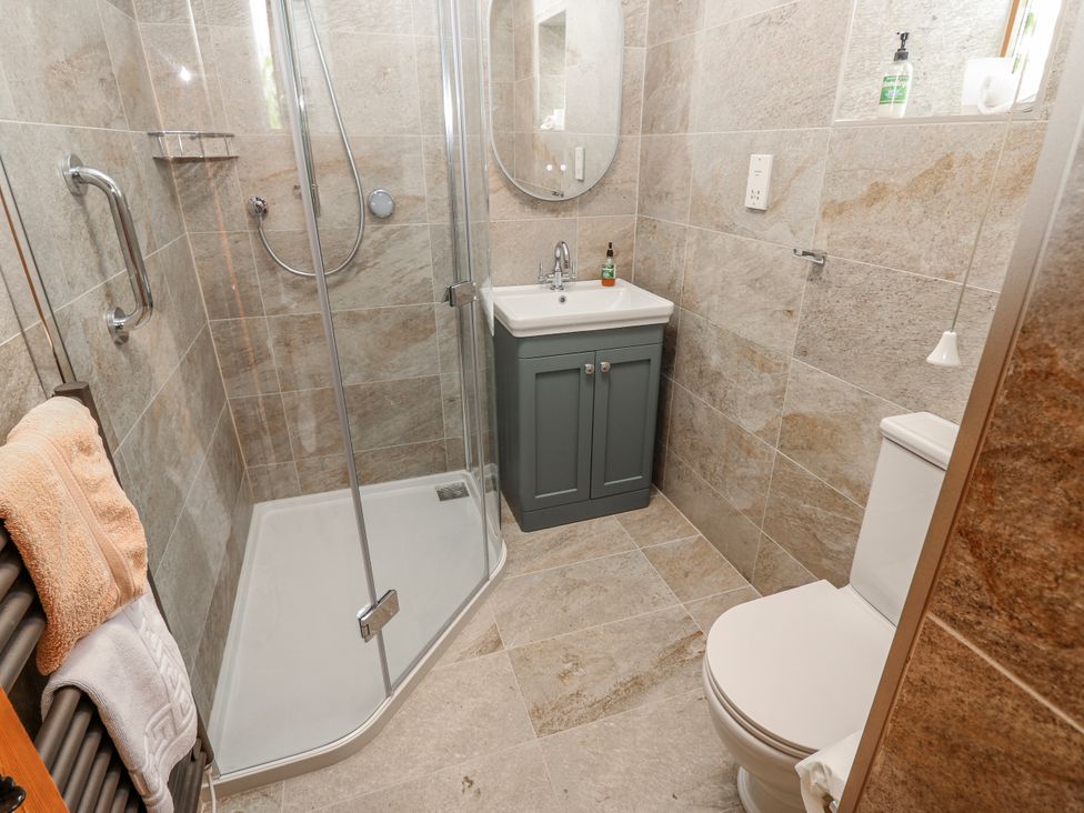 A bathroom featuring a shower, sink, toilet and towel rail at Lovesome Cottage Northallerton