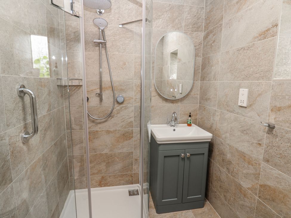 A bathroom with a shower and sink at Lovesome Cottage in Northallerton