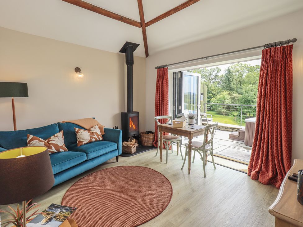A living room with a sofa and table at Acorn in Bowness-on-Windermere