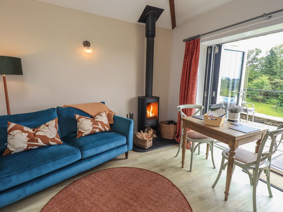 A living room with a sofa and table at Acorn in Bowness-on-Windermere