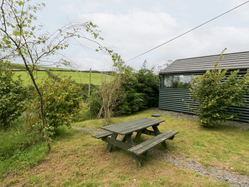 A garden with a table and benches at Ash Lodge in Pennington near Ulverston