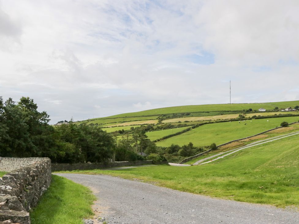 A scenic view of a rural landscape with a road and hills at Ash Lodge in Pennington near Ulverston