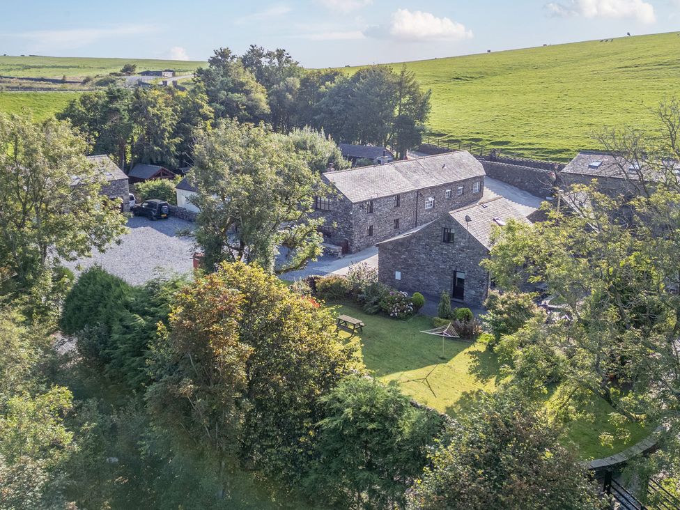 An outdoor view of buildings and garden at Ash Lodge Pennington near Ulverston