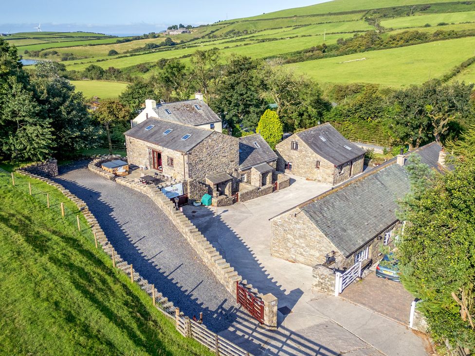 An outdoor area with stone buildings and a garden at Ash Lodge Pennington near Ulverston