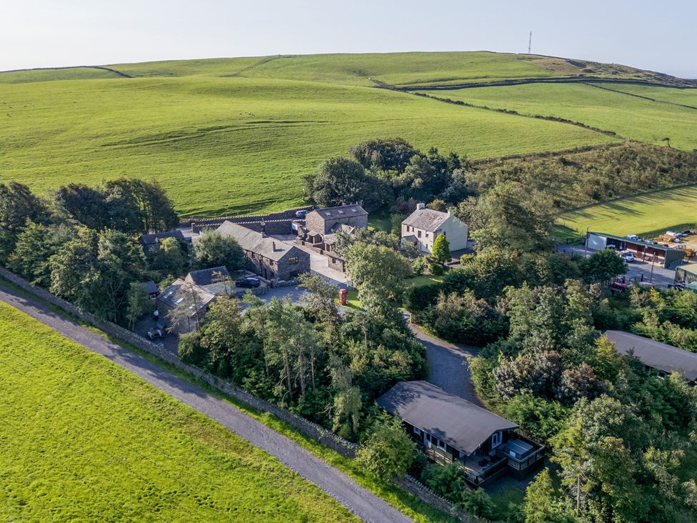 An aerial view of a rural area with buildings and fields at Ash Lodge Pennington near Ulverston
