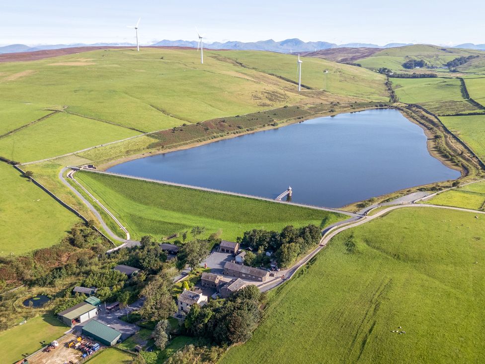 An aerial view of a lake and farmland at Ash Lodge in Pennington near Ulverston