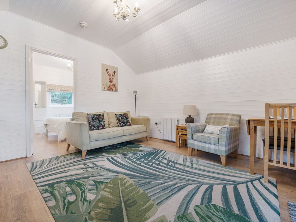 A living room with sofa and armchairs at Ash Lodge Pennington near Ulverston