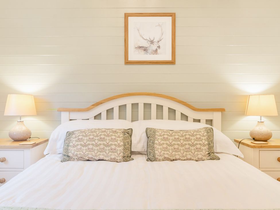 A bedroom with a bed and bedside tables at Ash Lodge in Pennington near Ulverston