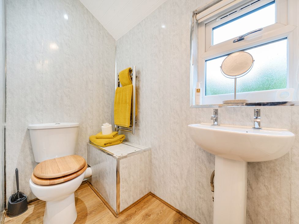 A bathroom with a toilet and sink at Ash Lodge in Pennington near Ulverston