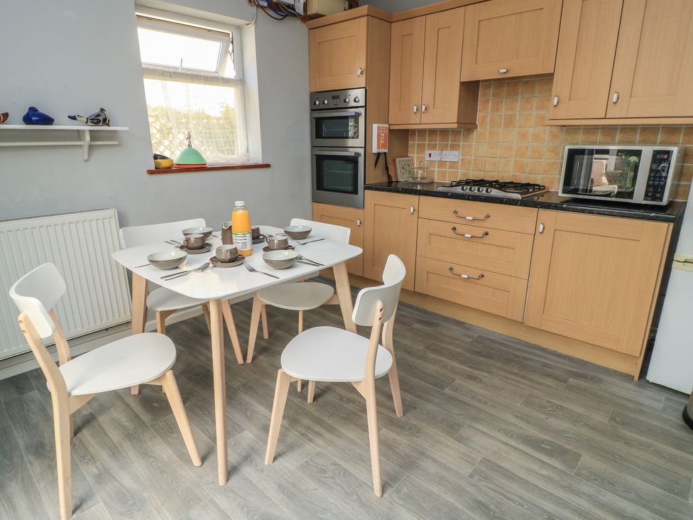 A kitchen with a table and chairs at Lamora in Cheddar