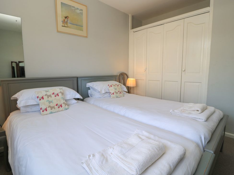 A bedroom with two beds and a wardrobe at Lamora in Cheddar
