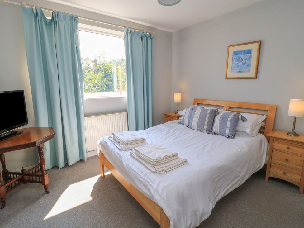 A bedroom with a bed and television at Lamora in Cheddar