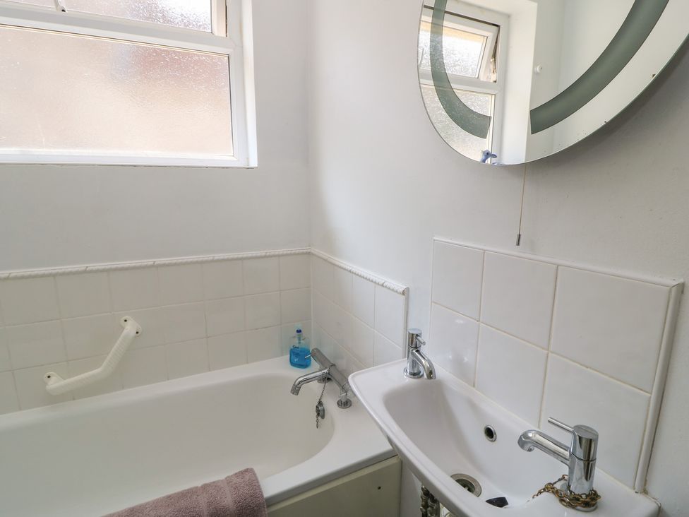 A bathroom with a bathtub and sink at Lamora in Cheddar