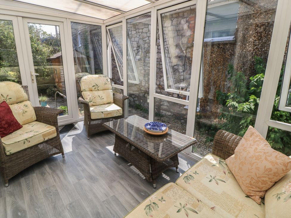 A conservatory with seating and a coffee table at Lamora in Cheddar