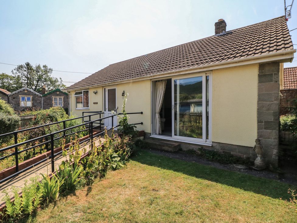 An exterior view of a house with a garden at Lamora in Cheddar