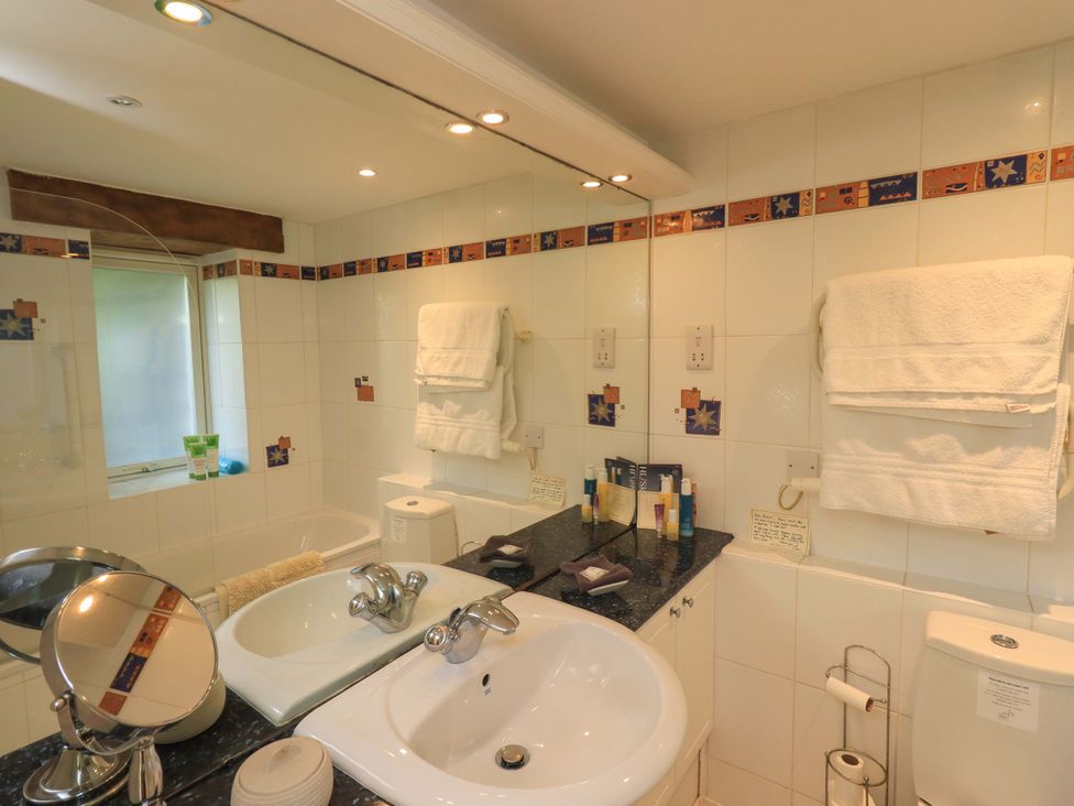 A bathroom with sink and toilet at Pheasant Cottage Beckside near Cartmel
