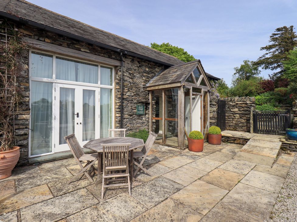 An outdoor area with a table and chairs at Pheasant Cottage near Cartmel