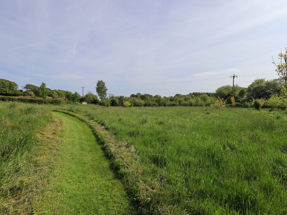 A grassy path through a field at Pheasant Cottage Beckside near Cartmel