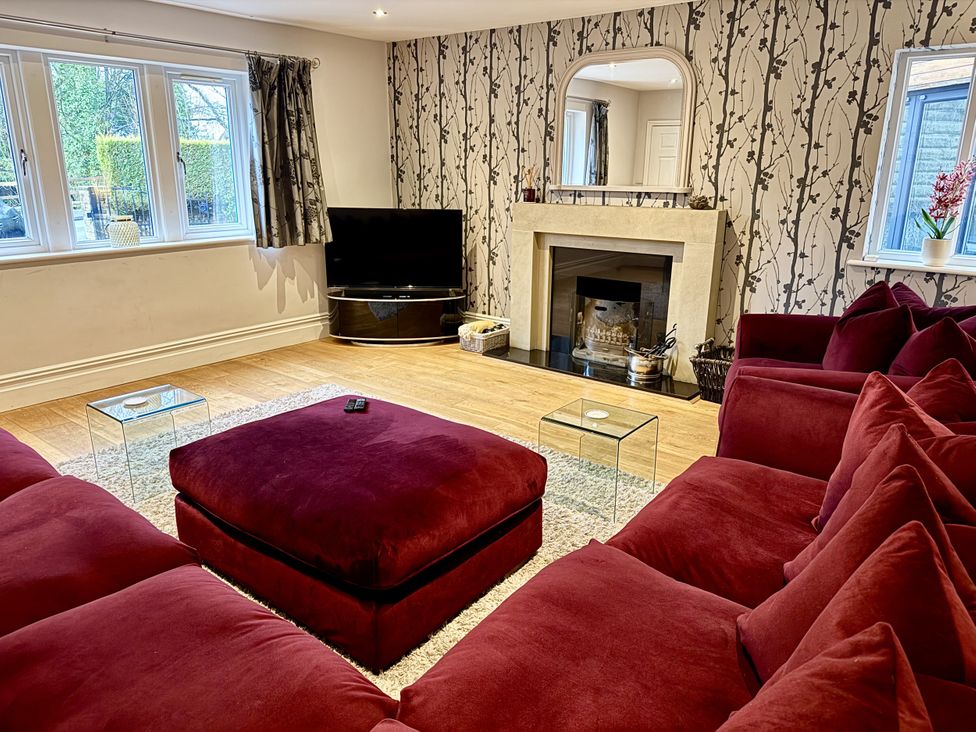 A living room with a sofa and television at Willow Brook in Glossop