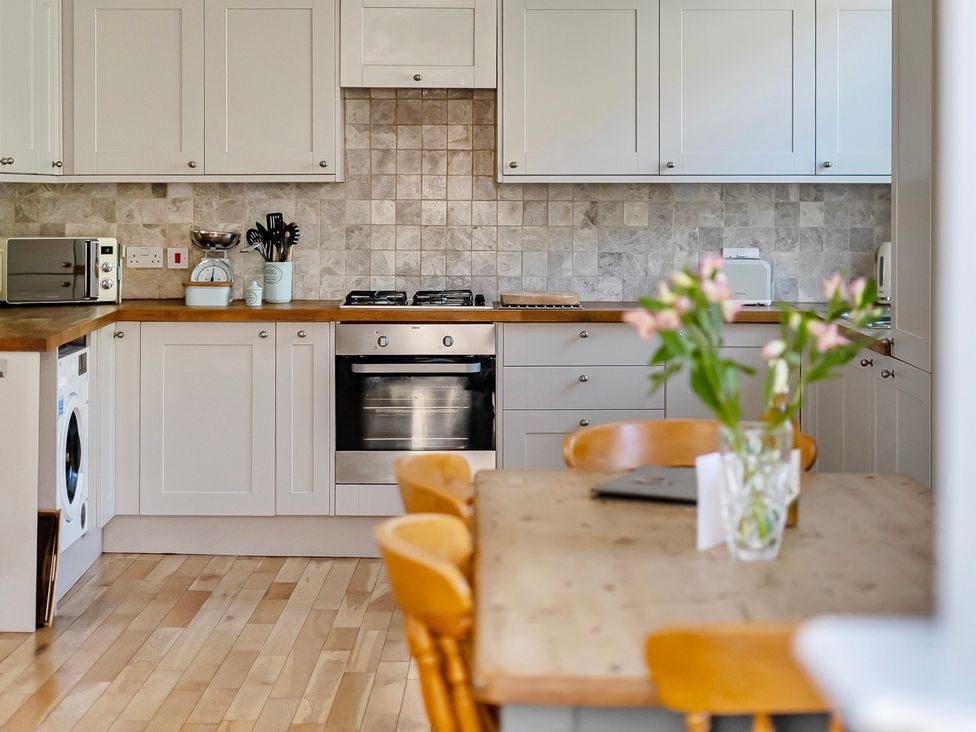 A kitchen with appliances and a dining area at East Wing in Crewkerne