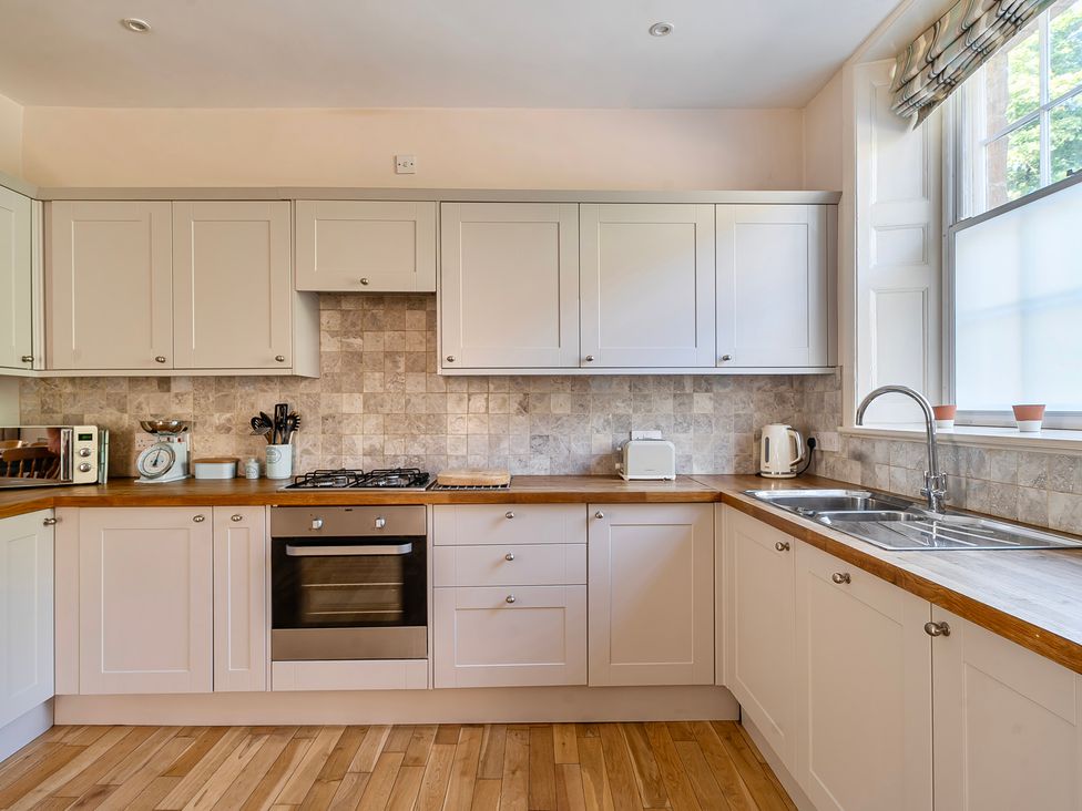 A kitchen with cabinets and appliances at East Wing in Crewkerne