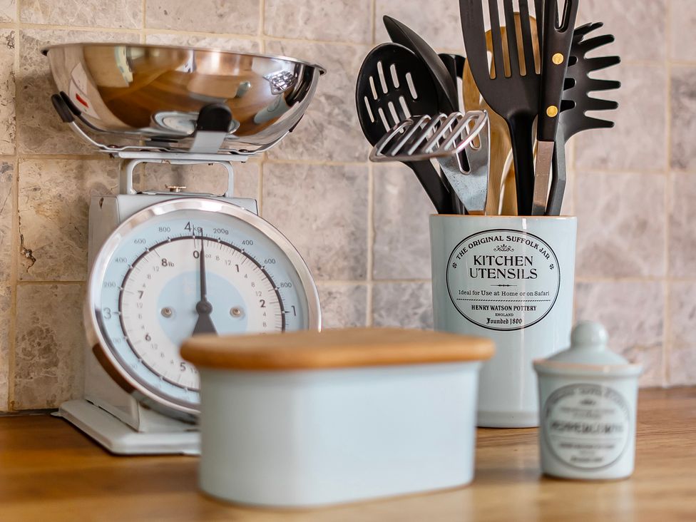 A kitchen scale and utensils in a container at East Wing in Crewkerne