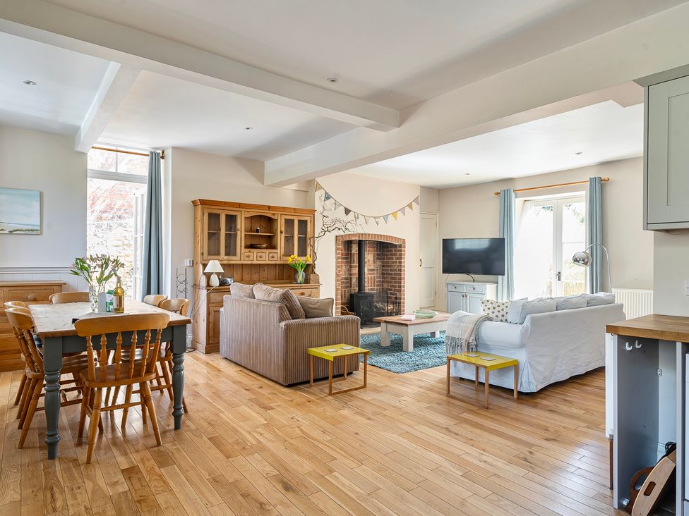 A living room with a dining area and sofa at East Wing in Crewkerne