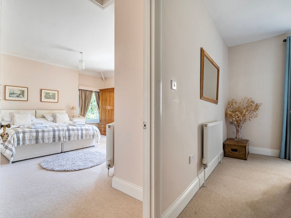 A bedroom with a bed and furniture at East Wing in Crewkerne