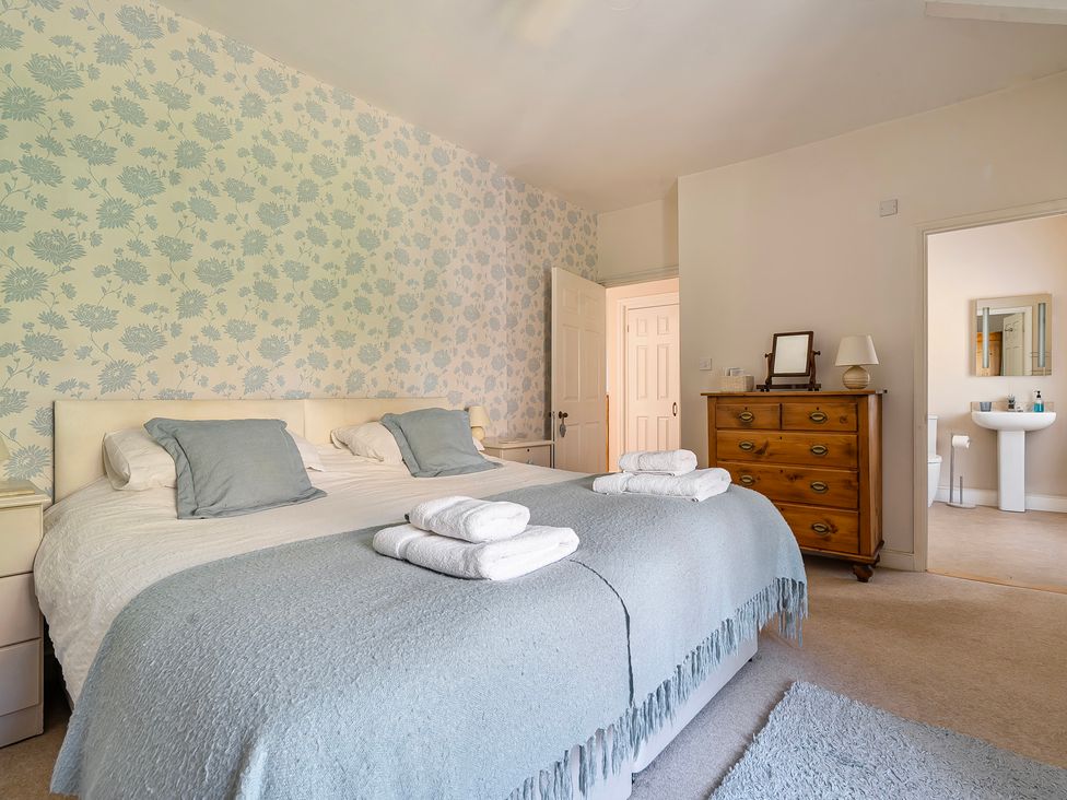 A bedroom with a bed and a dresser at East Wing in Crewkerne