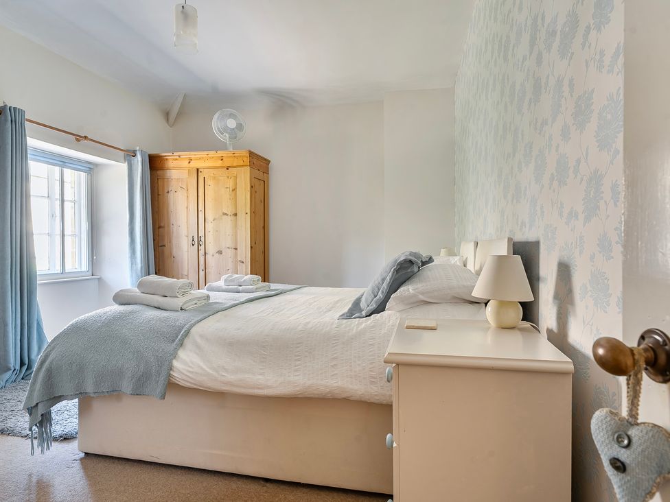 A bedroom with a bed and wardrobe at East Wing in Crewkerne