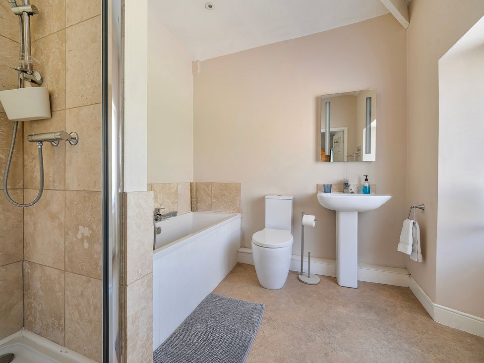 A bathroom with a bathtub and sink at East Wing in Crewkerne