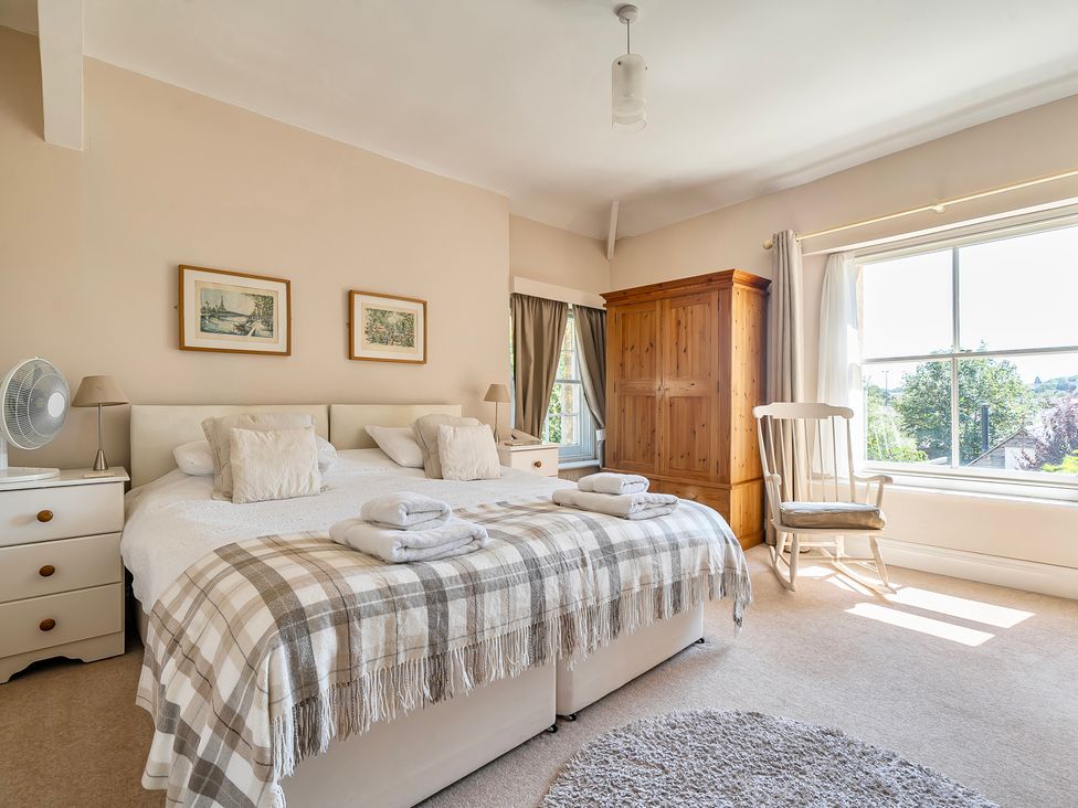A bedroom with a bed and wardrobe at East Wing in Crewkerne