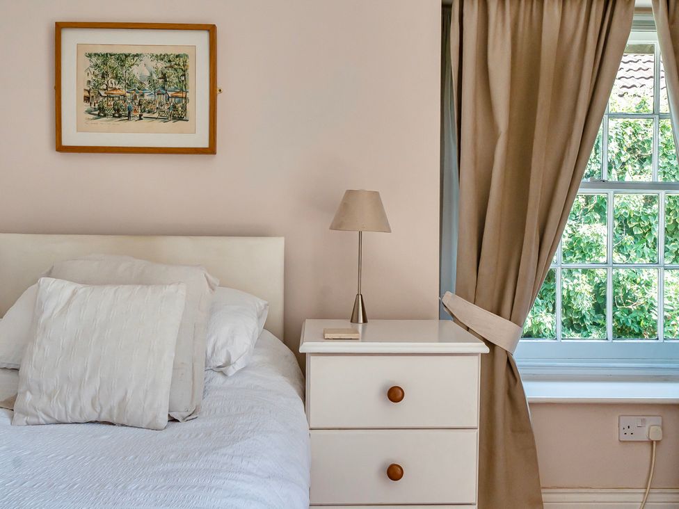 A bedroom with a bed and nightstand at East Wing in Crewkerne