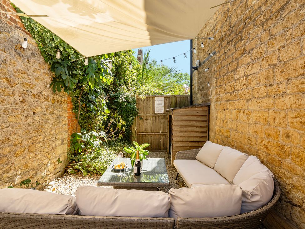 An outdoor area with a seating arrangement and plants at East Wing, Crewkerne