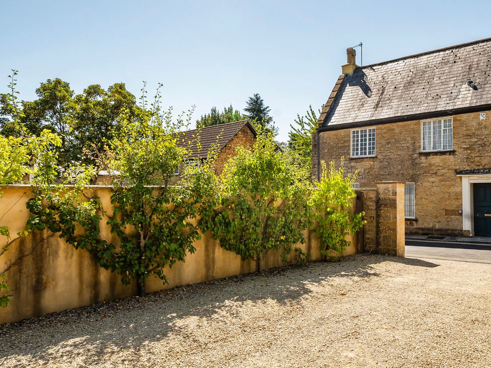 An outdoor view of trees and a house at East Wing in Crewkerne