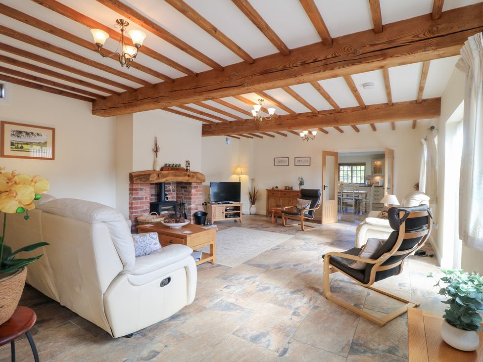 A living room with a fireplace and sofa at The Dairy in Eastwood